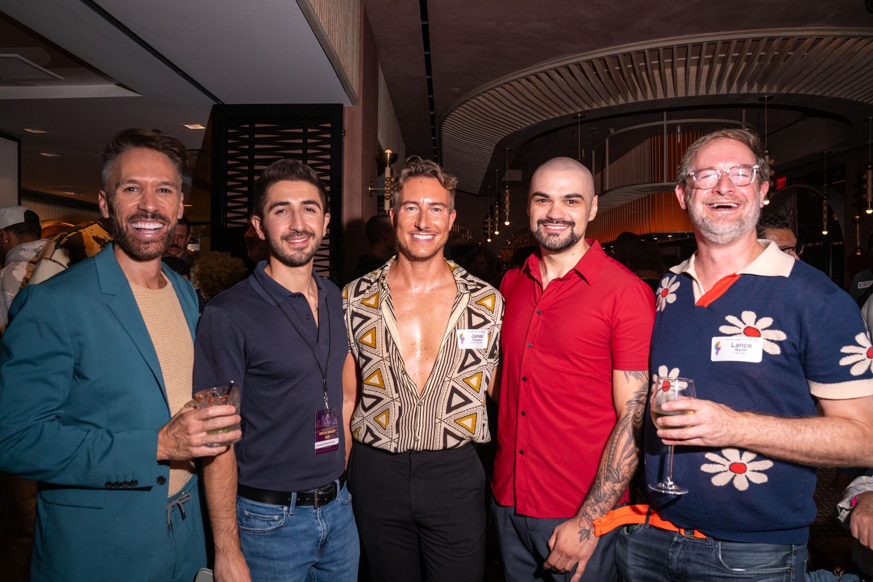 Five attendees posing in a row in the lounge