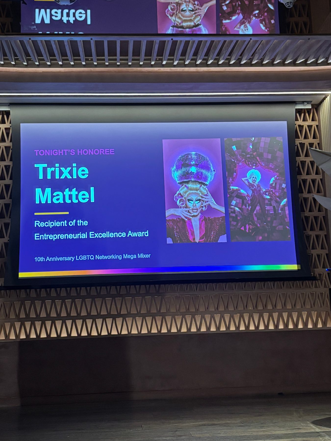 Projection screen announcing the evening's honoree, Trixie Mattel, and the Entrepreneurial Excellence Award