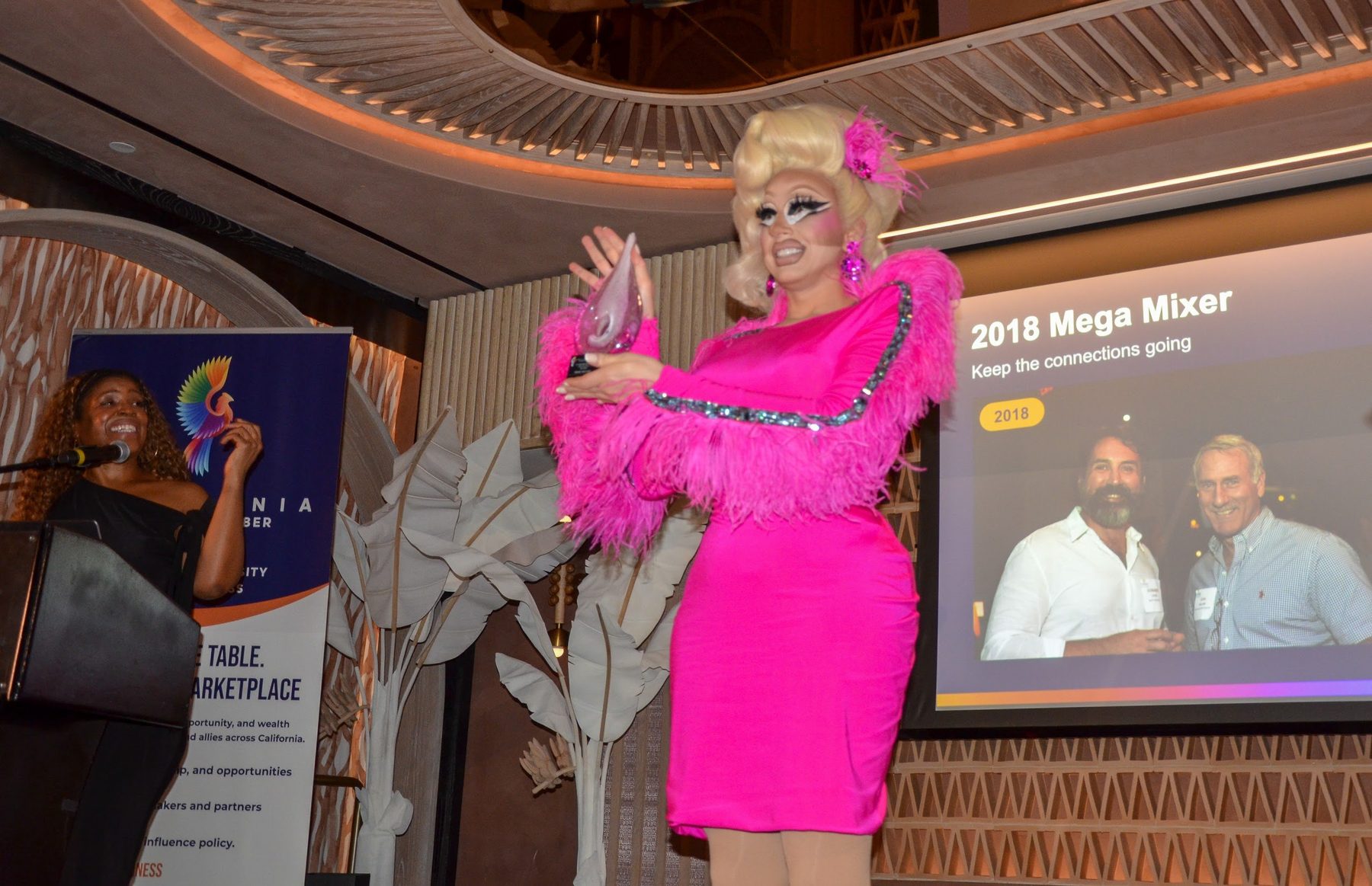 The honoree raising the award beside the presenter